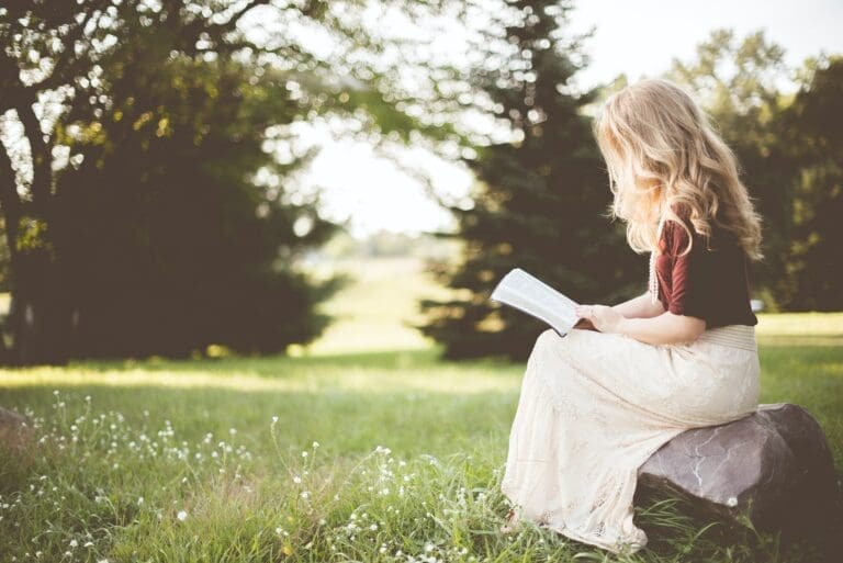 Woman outside reading the Bible