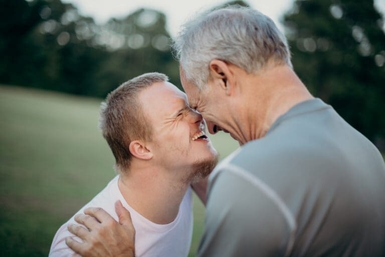 Father and son laughing, son has down syndrome