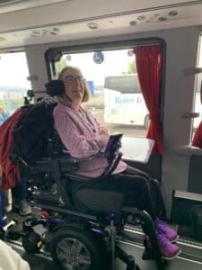 Debbie in handicapped tour bus by the window