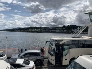 A picture of other tour buses (like ours) crossing the loch of water by boat