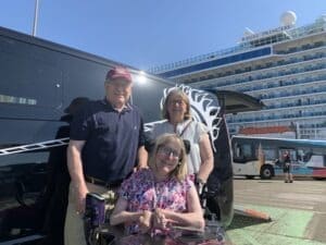 In front of our accessible taxi (which has a unicorn logo)